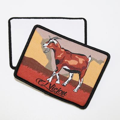 China Manufacturer Custom Brand Animal Design Merrow Edge Iron on Tags Woven Clothes Labels Patches for Hats